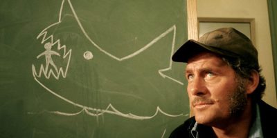 Jaws - Quint - in front of the chalkboard.