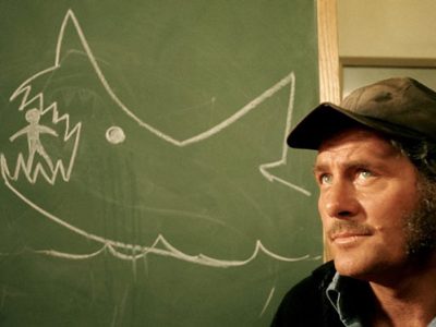 Jaws - Quint - in front of the chalkboard.