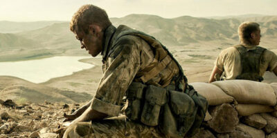 A British soldier in desert military uniform, looking tired and dirty, in the film Kajaki - The True Story.