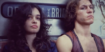 Deborah Van Valkenburgh and Michael Beck sit on a subway train in The Warriors.