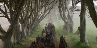 Kingsroad in Game of Thrones - known in Northern Ireland as the Dark Hedges. Here it is seen in Game of Thrones, basked in a hazy mist.