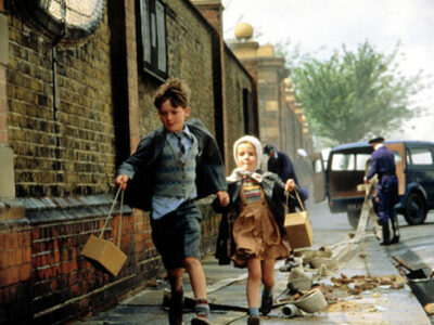 Children running between rubble in war-torn Britain in John Boorman's Second World War movie Hope & Glory