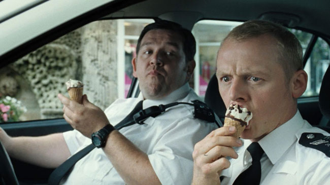 Simon Pegg and Nick Frost eating ice cream in the film Hot Fuzz - best comedy movies in the 2000s