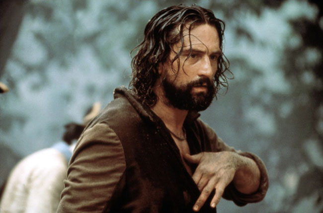 Robert De Niro with mullet-length greasy hair and a cropped beard in the film, The Mission.