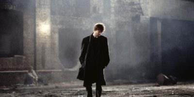 David Thewlis stands in a dark London street in the film, Naked by writer-director Mike Leigh.