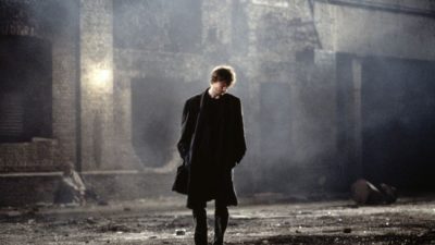 David Thewlis stands in a dark London street in the film, Naked by writer-director Mike Leigh.