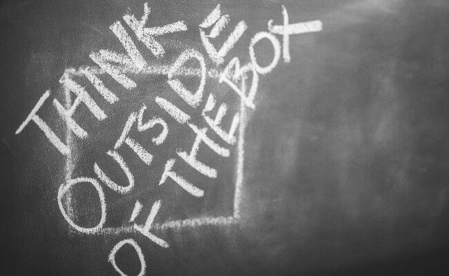A chalkboard depicting the phrase: "Think outside of the box"