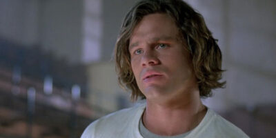 Richard Tyson, in mid-shot, sports mullet-length hair in the 1987 film, Three O'Clock High.