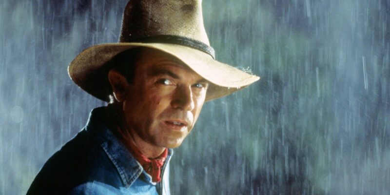 Sam Neill standing in the rain protected by a fedora hat in Steven Spielberg's film Jurassic Park (1993)