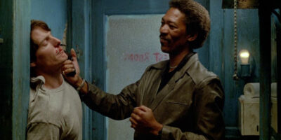 Morgan Freeman holds a gun to Christopher Reeve's face in the film Street Smart.