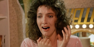 Madolyn Smith shrieks in fright as she sees something off-camera that shocks her in the 1987 film, The Caller.